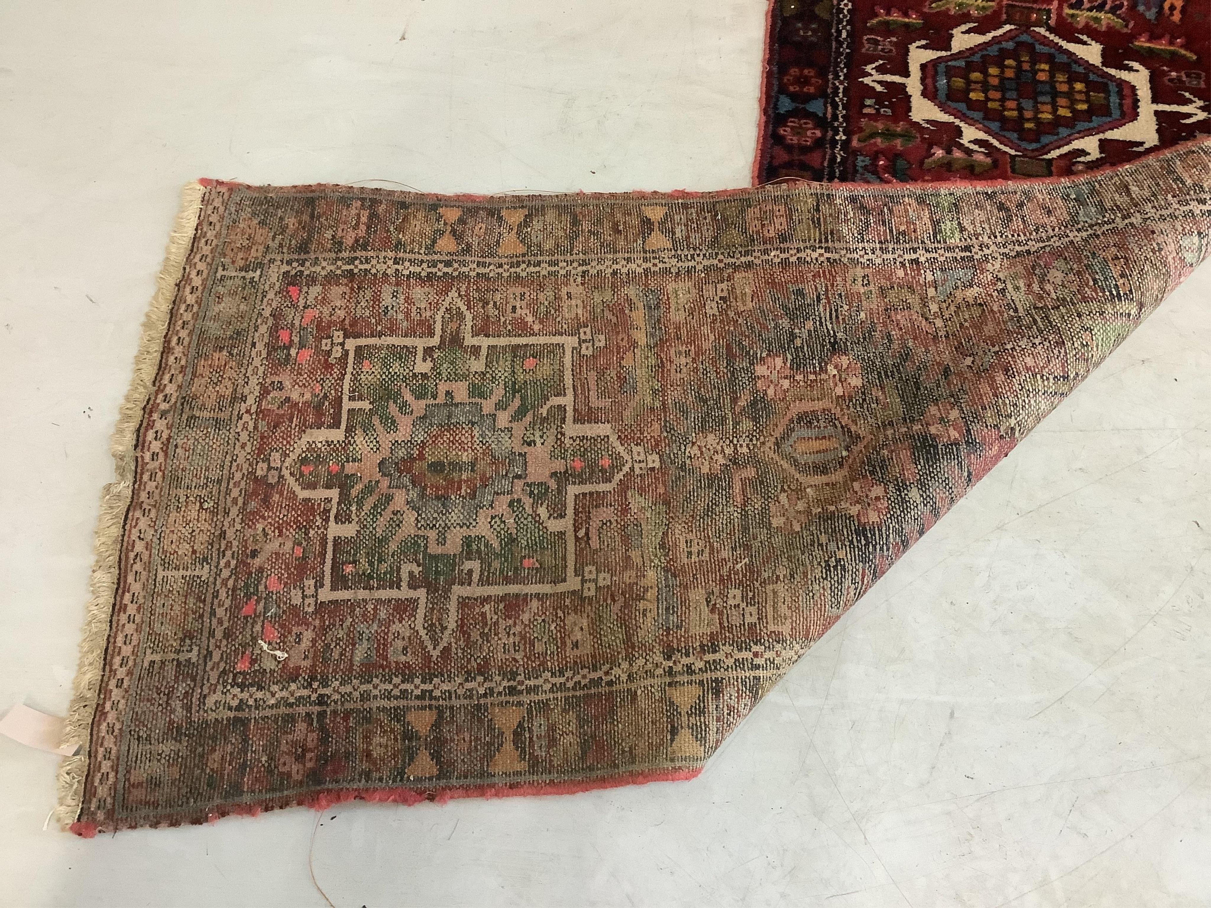 A Persian dark red ground runner, 386 x 88cm. Condition - poor, worn at both ends